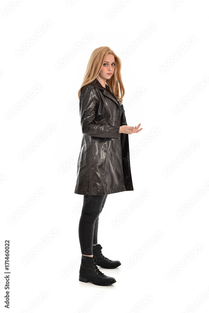 full length portrait of girl wearing black clothes with long leather jacket. standing pose on white background. full length portrait of girl wearing black clothes with long leather jacket. standing pose on white background.