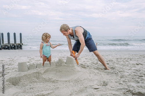 Father and daughter making sand castle at Cape May Beach photo