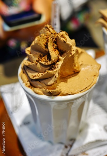 Mug of hot chocolate with chocolate whipped cream on top 
