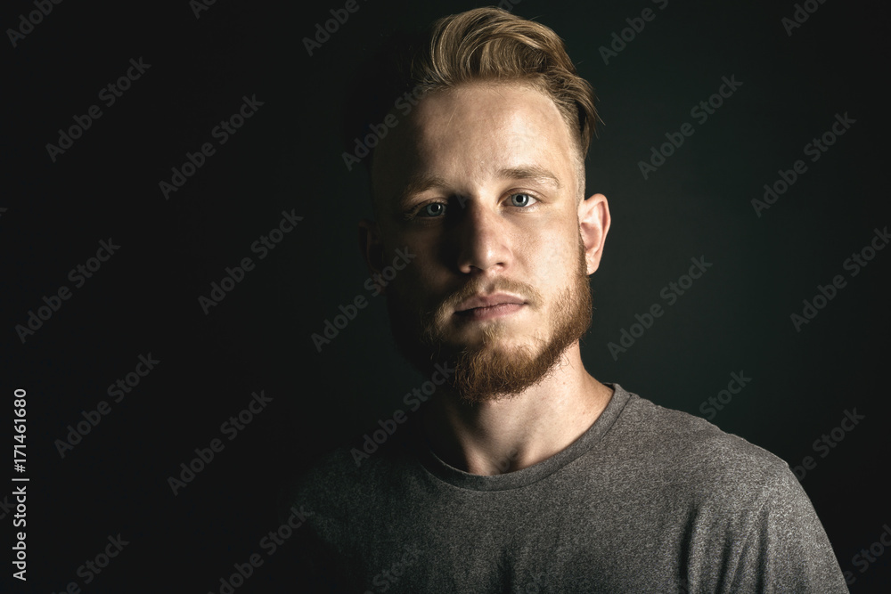 Obraz premium portrait of young man above black background