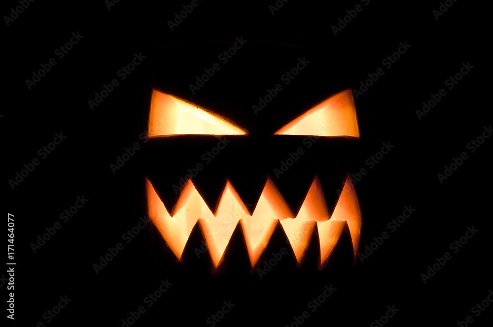 Fototapeta premium Glowing Halloween pumpkin in the dark.
