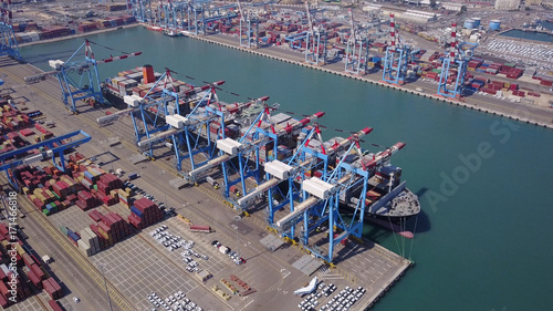 Fully loaded container ship docked at freight port terminal