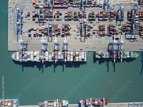 Fully loaded container ship docked at freight port terminal