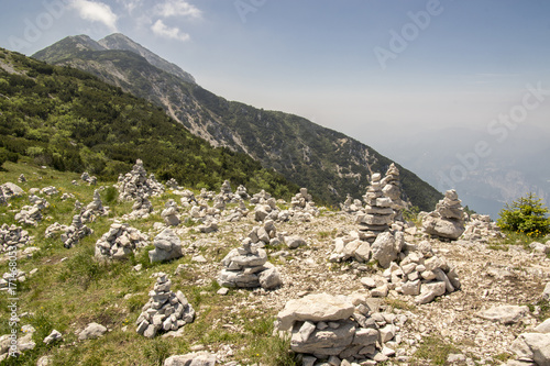 View point with white stone cairns on hiking trail Alta Via del Monte Baldo, ridge way in Garda Mountains photo