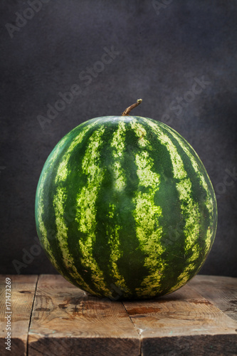 Watermelon on a wooden table. Tasty and healthy berry. Flight. Delicious.