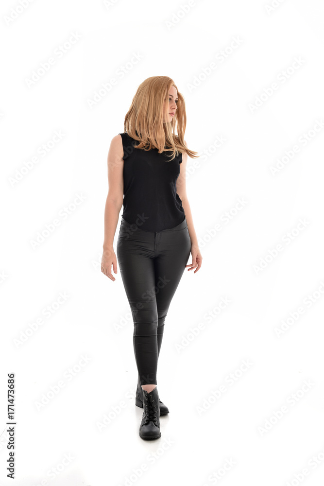 full length portrait of girl wearing black clothes with long leather jacket. standing pose on white background. full length portrait of girl wearing black clothes with long leather jacket. standing pose on white background.