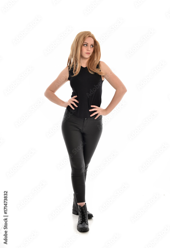 full length portrait of girl wearing black clothes with long leather jacket. standing pose on white background. full length portrait of girl wearing black clothes with long leather jacket. standing pose on white background.