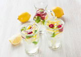 Fresh lemon and raspberry water drink / Fresh lemon and raspberry cold water drink lemonade with mint in two glass