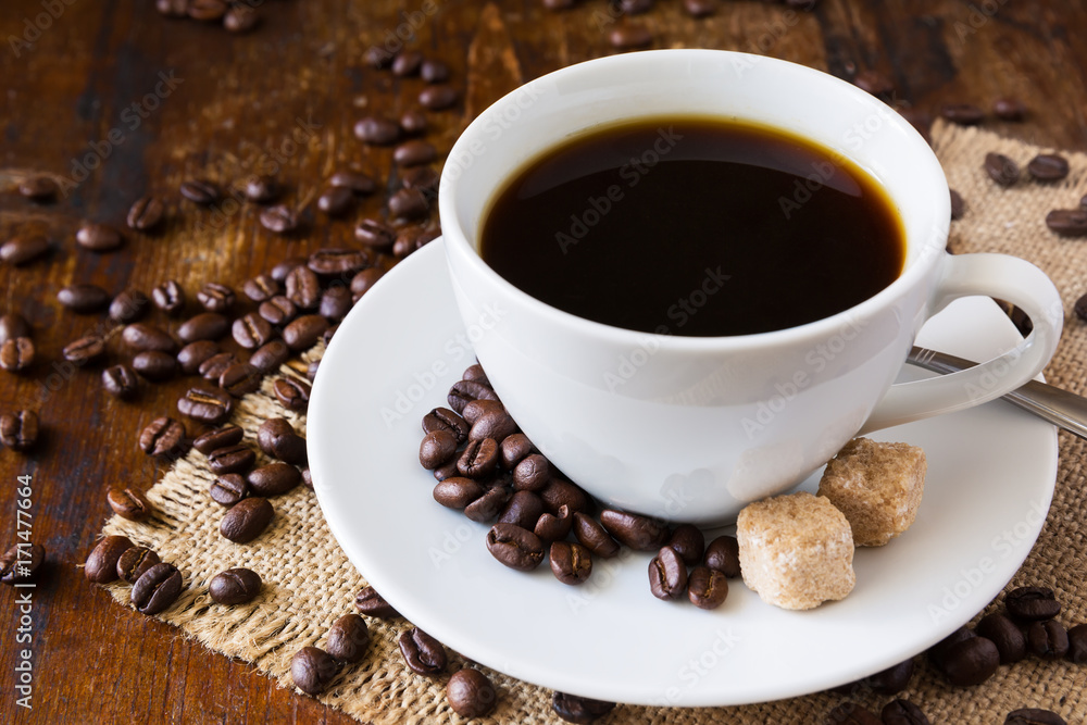 Coffee cup with coffee beans and sack background Coffee cup with coffee beans and sack background