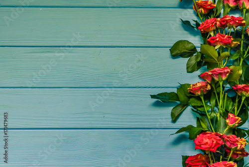 Still life with roses flowers on the wooden background