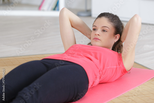 beautiful doing sit ups on the mattress at home