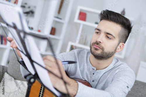 coustic guitar player rehearses his new song photo