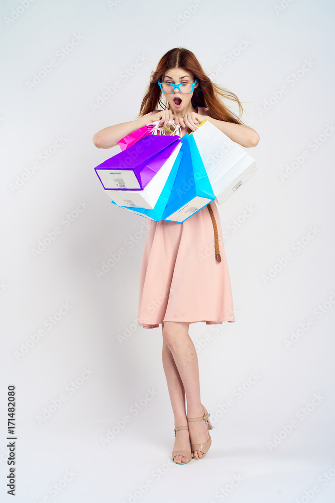 woman holds many packages, emotions, surprise woman holds many packages, emotions, surprise