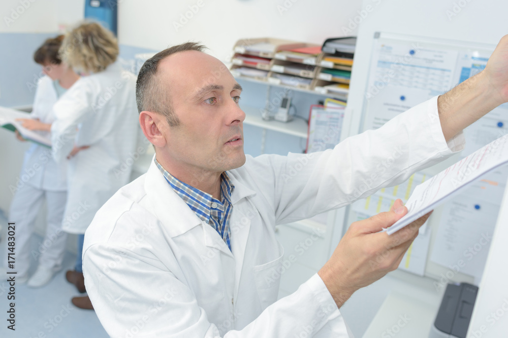 Laboratory worker filing paperwork Laboratory worker filing paperwork
