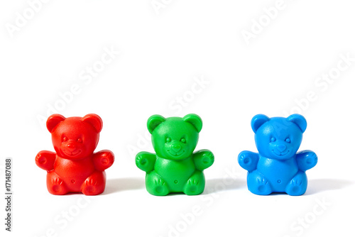 Red  green and blue plastic toy bears isolated on white background