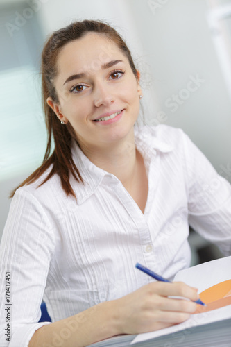 portrait of a female student at workplace studying