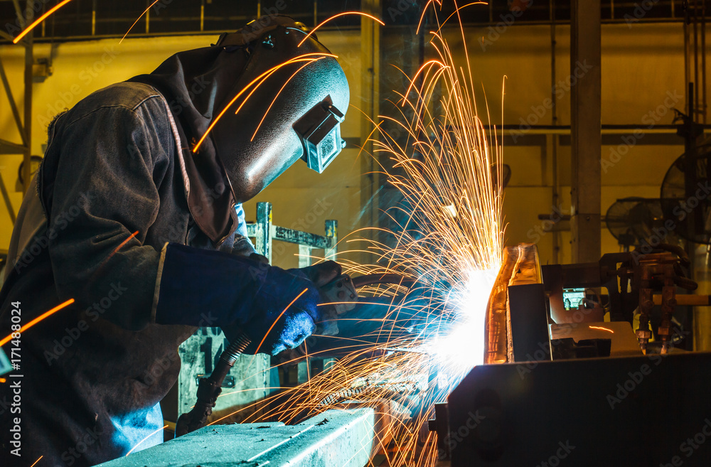 Worker, welding in a car factory with sparks, manufacturing, industry
Worker, welding in a car factory with sparks, manufacturing, industry