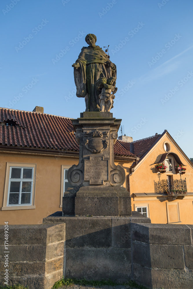 Statue of Nicholas of Tolentino on the south side of the Charles Bridge (Karluv most) in Prague, Czech Republic, on a sunny day.