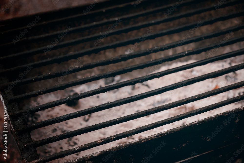 Charcoal grill / View of empty dirty charcoal grill. Dark tone. Charcoal grill / View of empty dirty charcoal grill. Dark tone.