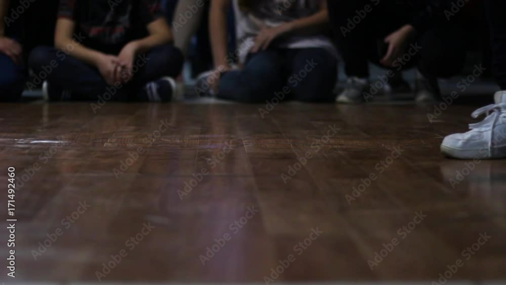 A girl in white sneakers dances on a battles in the style of a hiphop. A girl in white sneakers dances on a battles in the style of a hiphop.
