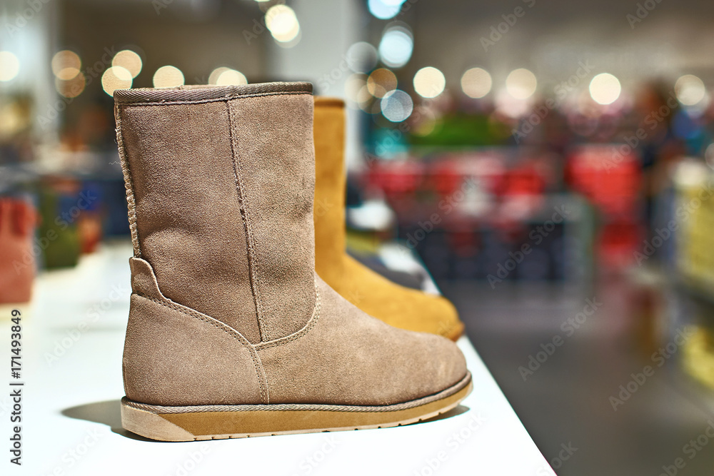 Ugg style light brown boots in a luxury store