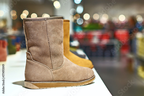 Obraz na płótnie Ugg style light brown boots in a luxury store w salonie