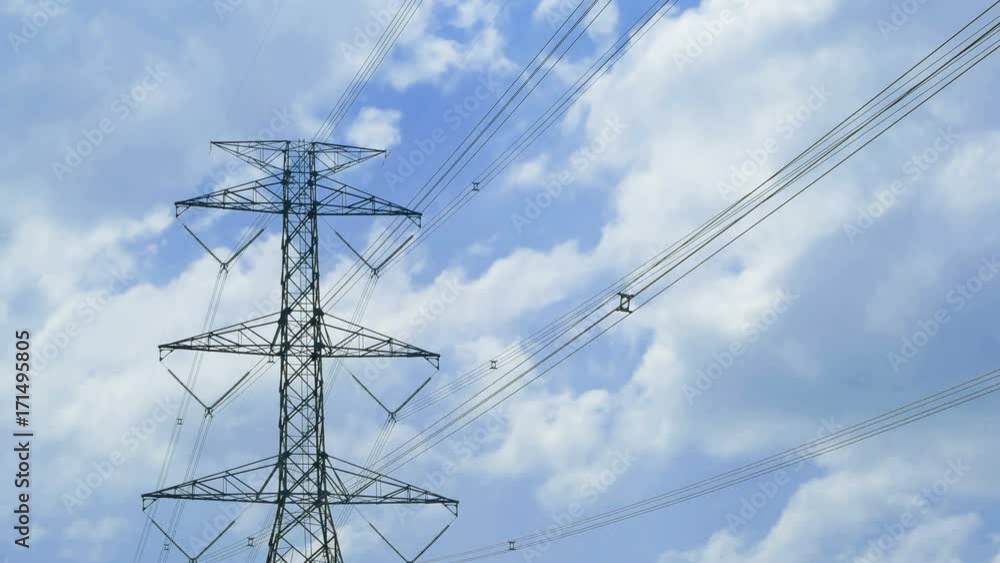 tall electric masts against sun and cloudy sky - timelapse tall electric masts against sun and cloudy sky - timelapse