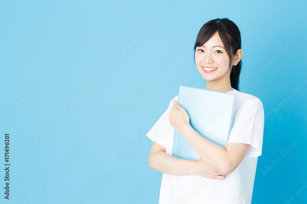 portrait of asian nurse isolated on blue background portrait of asian nurse isolated on blue background