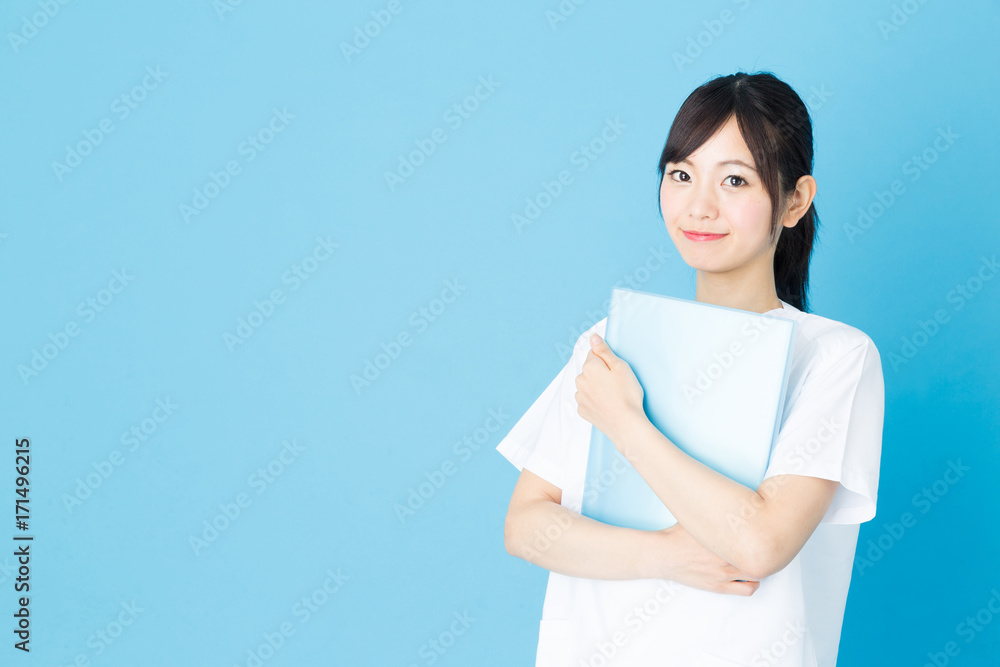portrait of asian nurse isolated on blue background portrait of asian nurse isolated on blue background