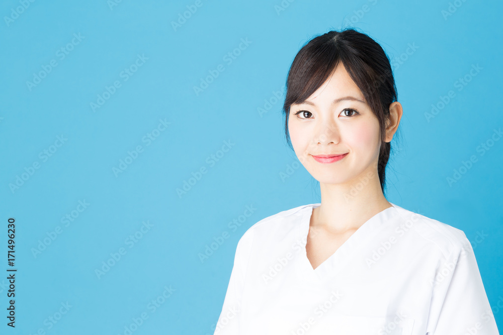 portrait of asian nurse isolated on blue background portrait of asian nurse isolated on blue background
