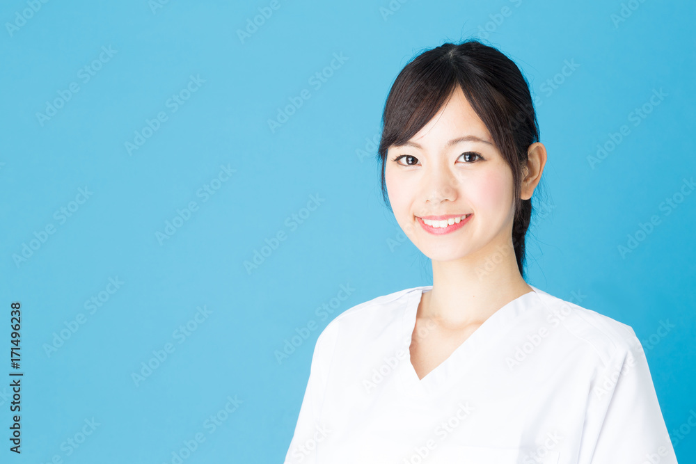 portrait of asian nurse isolated on blue background portrait of asian nurse isolated on blue background