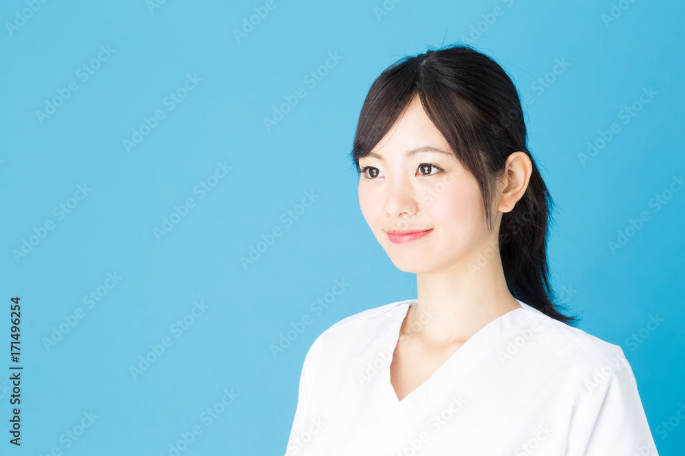 portrait of asian nurse isolated on blue background portrait of asian nurse isolated on blue background