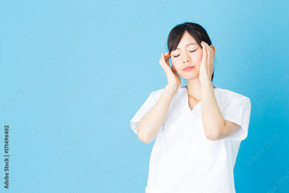 portrait of asian nurse isolated on blue background portrait of asian nurse isolated on blue background
