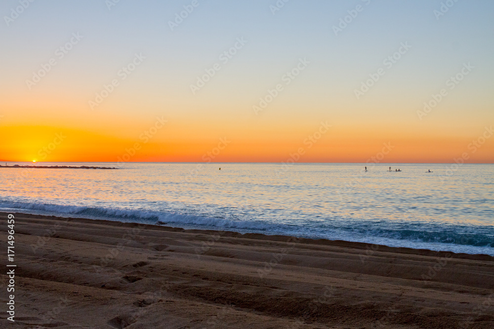 Barceloneta Beach in Barcelona with colorful sky at sunrise Barceloneta Beach in Barcelona with colorful sky at sunrise