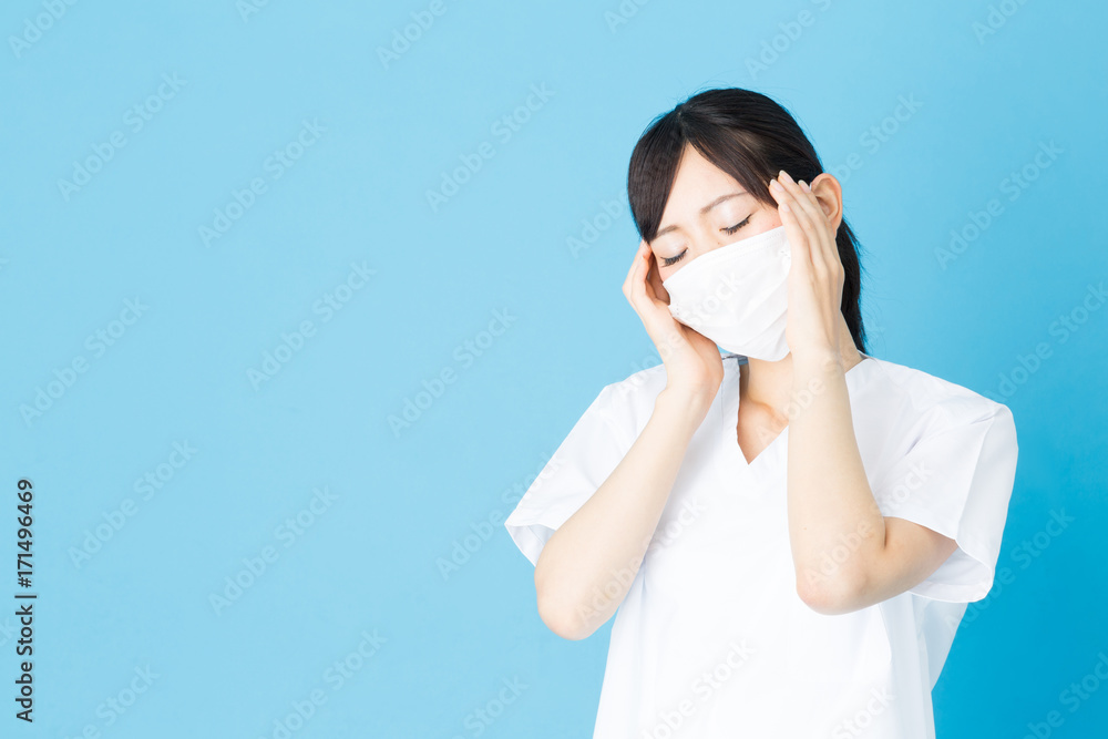 portrait of asian nurse isolated on blue background portrait of asian nurse isolated on blue background