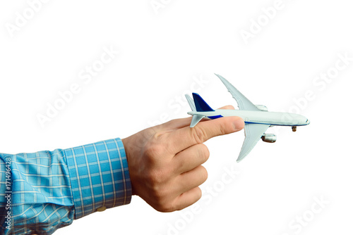 Departure for holidays concept. Man holding plane in his hand. Planning the departure.