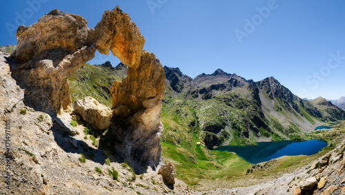 Fototapeta Naklejka Na Ścianę i Meble -  The famous Arc de Tortisse, natural arch in the national park of Mercantour (France) with the upper lake of Vens on the background