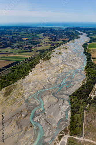 Aerial view of the Waimakariri River winding its way through the North Canterbury plains out to Pegasus Bay, New Zealand photo