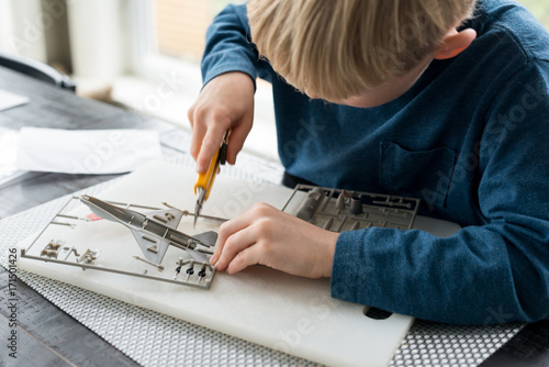Little boy building model airplane educational hobby photo