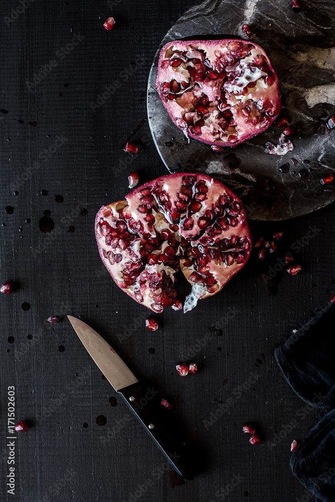 Pomegranate on a cut board Pomegranate on a cut board