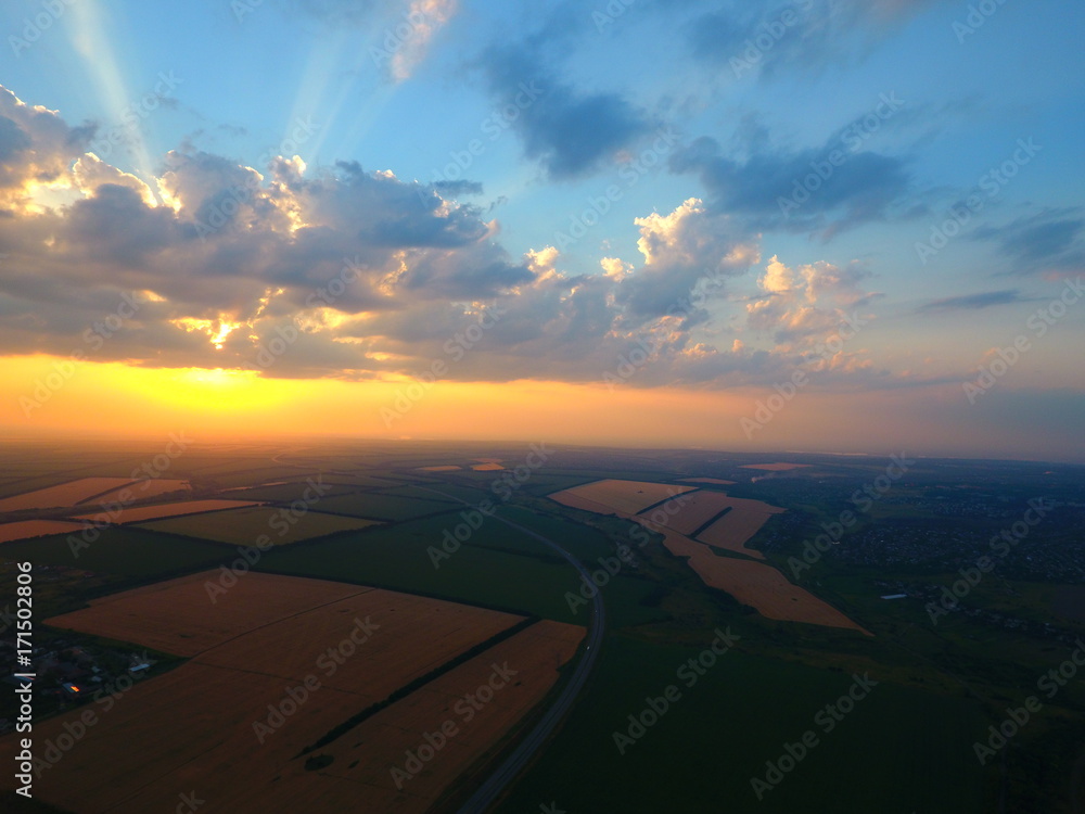 Aerial view of beautiful village, houses, roads. Sky, clouds, sunset. Aerial view of beautiful village, houses, roads. Sky, clouds, sunset.