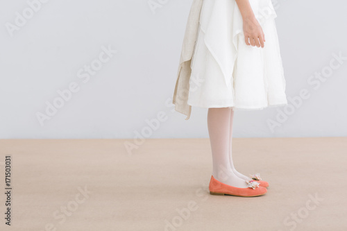 Young female with white dress and orange shoes