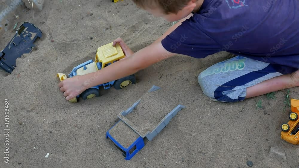 children play in the sand toys. toys for child sandboxes against the beach sand background. summer kids holidays background children play in the sand toys. toys for child sandboxes against the beach sand background. summer kids holidays background