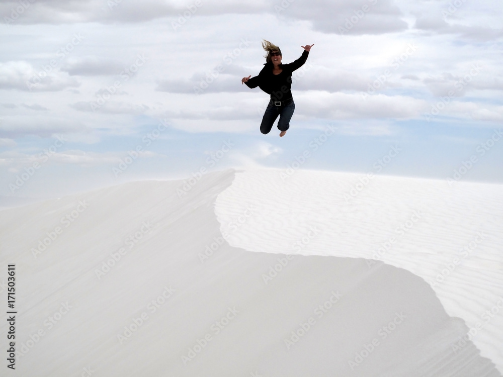 Woman jumping in White Sands National Monument, USA Woman jumping in White Sands National Monument, USA