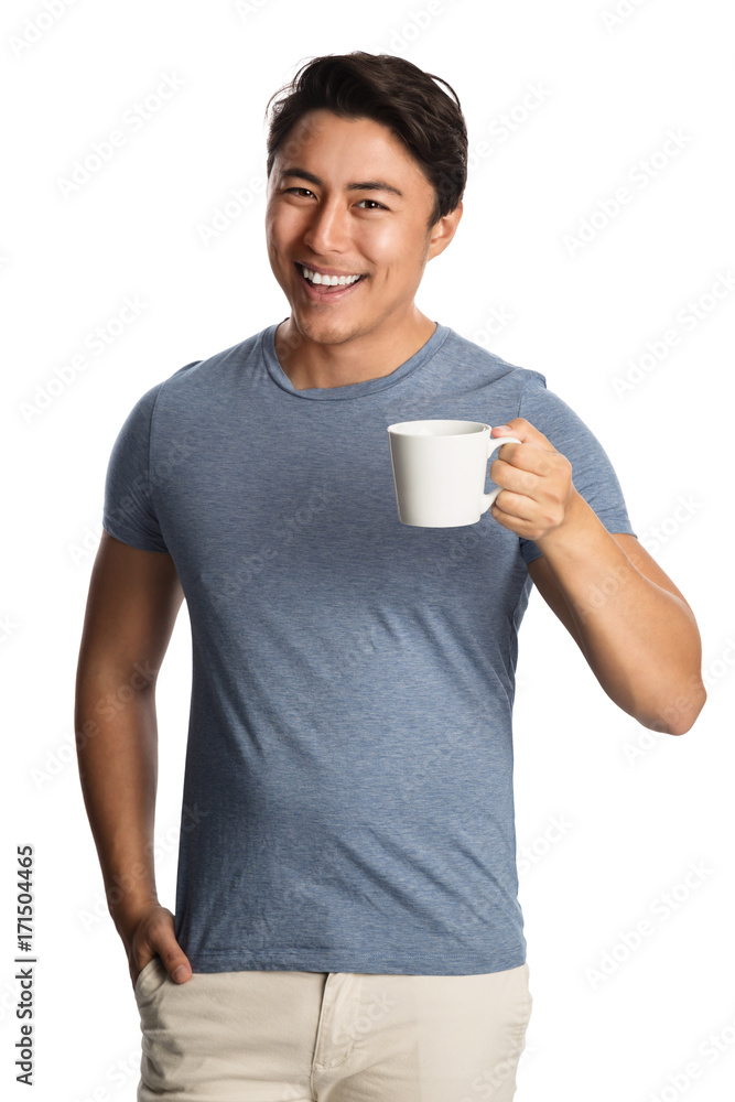Smiling attractive man wearing a blue shirt and bright pants, holding a mug standing in front of a white background. Smiling attractive man wearing a blue shirt and bright pants, holding a mug standing in front of a white background.