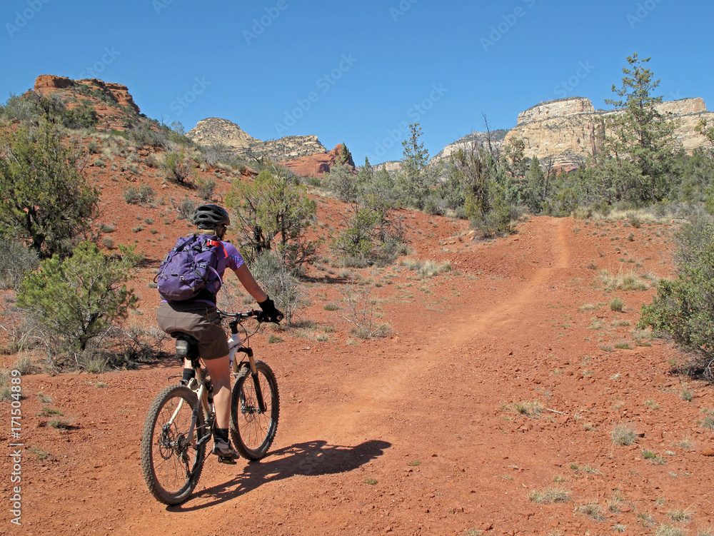 Woman mountain biking in the red rocks, Sedona, Arizona, USA