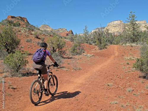 Woman mountain biking in the red rocks, Sedona, Arizona, USA