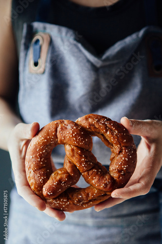 Woman holding freshly made pretzel