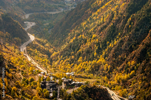 Main highway in Andorra bends and turns, near the Meritxell chapel, through a valley, at the peak of fall foliage colors photo