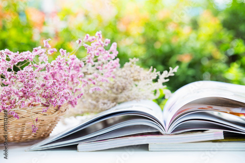 Open book  and there are dry flowers in rattan basket , colorful nature background and bokeh © Pattanan